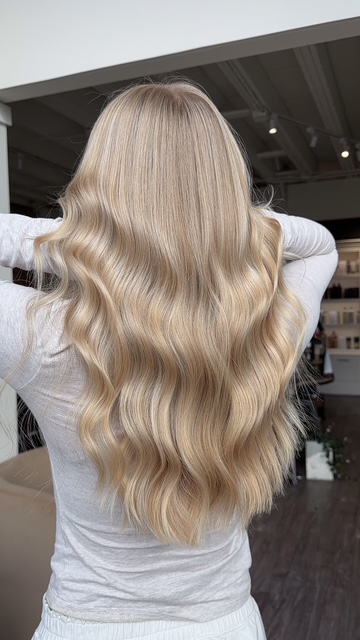 Golden blonde balayage with voluminous waves, back view, by Evelyn