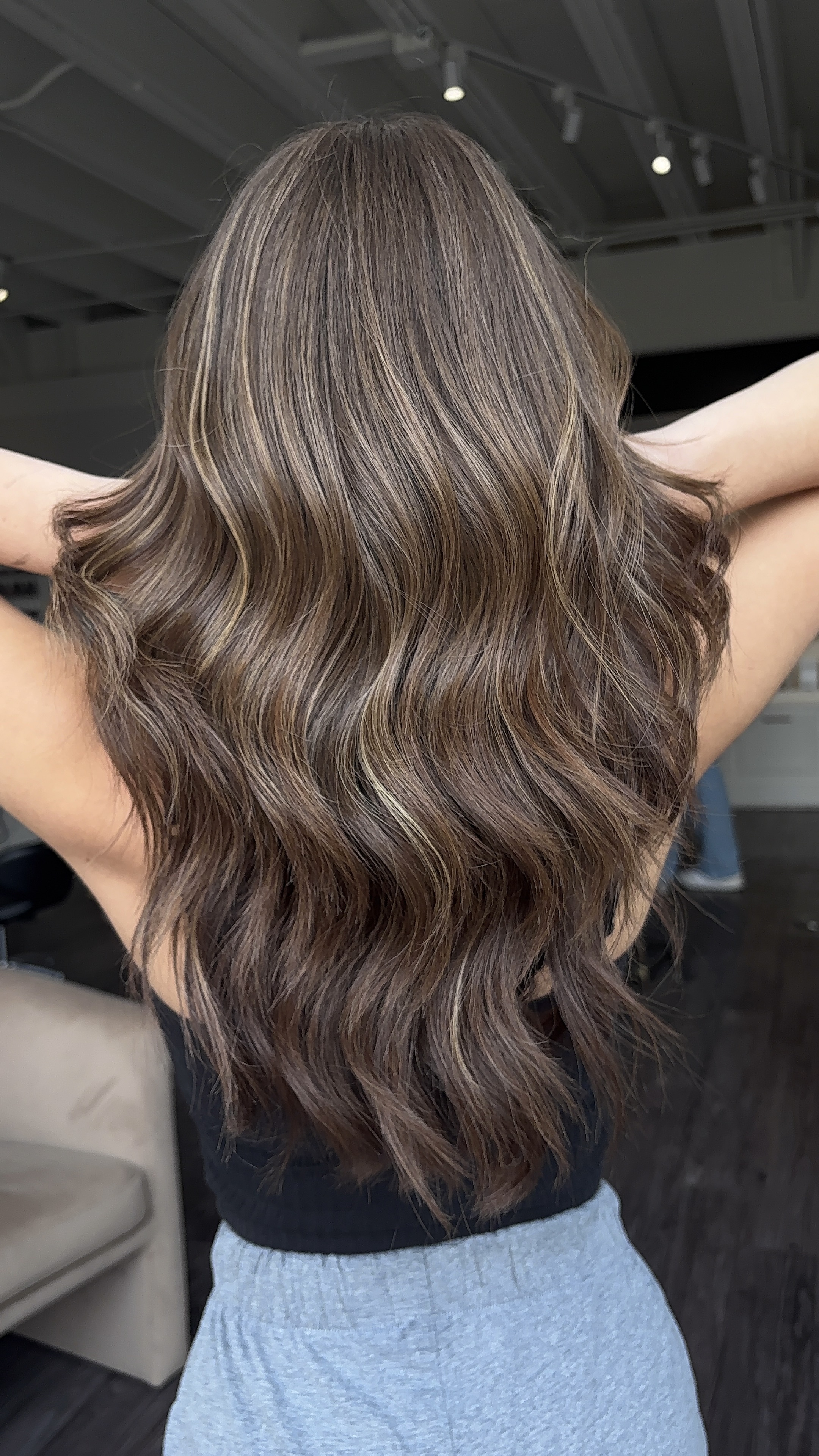 Brunette balayage with caramel highlights and waves by Evelyn